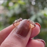 Rotating view of diamond open ring with graduated round stone tips.