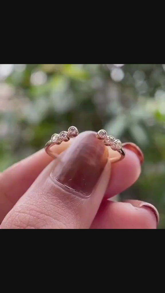 Rotating view of diamond open ring with graduated round stone tips.