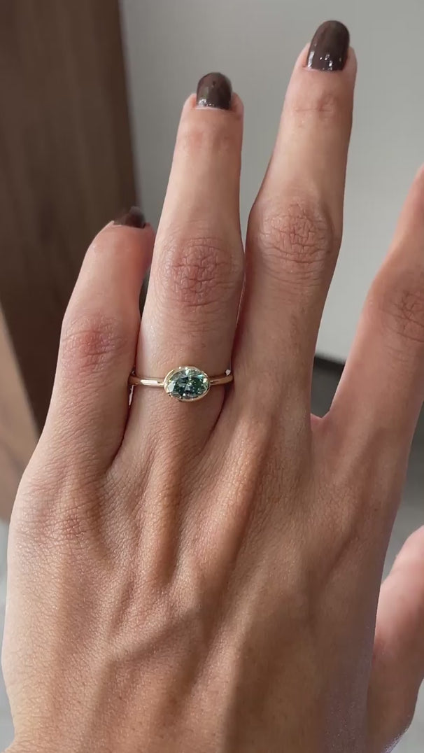 Oval blue green moissanite bezel set solitaire ring east west orientation