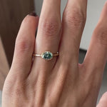 Oval blue green moissanite bezel set solitaire ring east west orientation