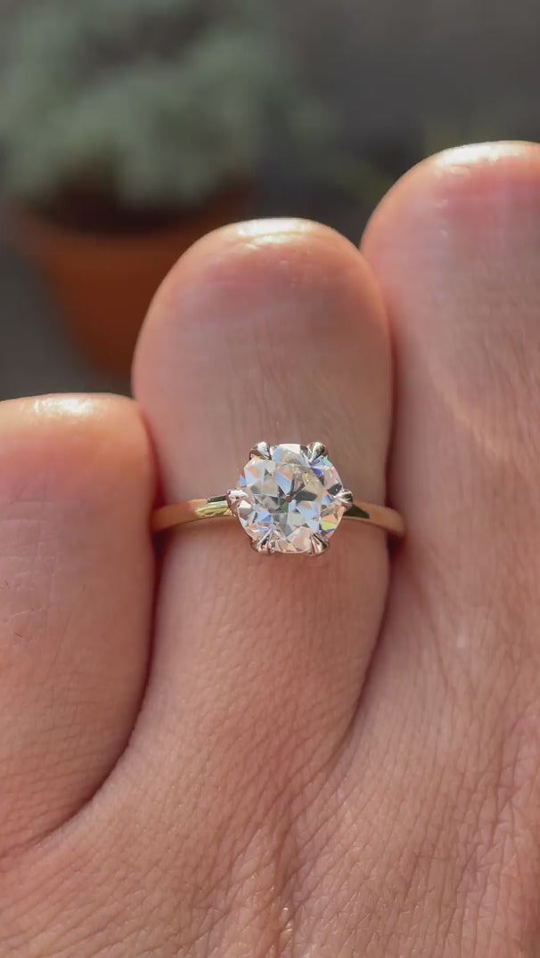 A close-up view of the Old European Cut Moissanite solitaire engagement ring, set in dual-tone 10K yellow-white gold