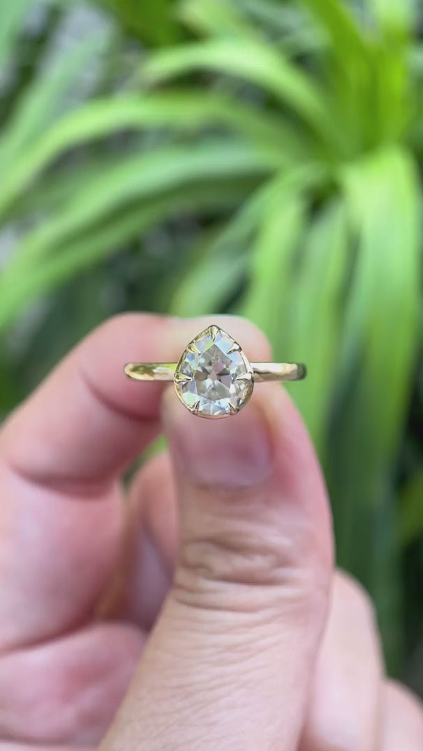 Pear moissanite solitaire ring rotating to show details