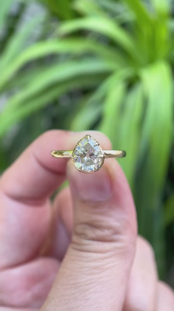 Pear moissanite solitaire ring rotating to show details