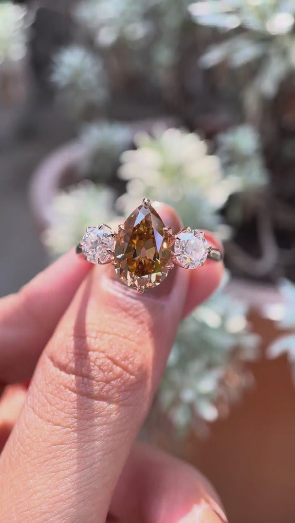 Three stone pear champagne moissanite engagement ring in yellow gold video