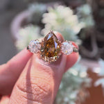 Three stone pear champagne moissanite engagement ring in yellow gold video