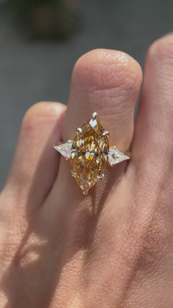 Marquise champagne three stone cathedral engagement ring yellow gold
