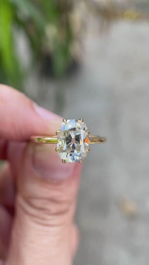 Elongated cushion Old Mine Cut moissanite solitaire engagement ring in 10K yellow gold detailed rotating view showing six-prong setting and slim band profile