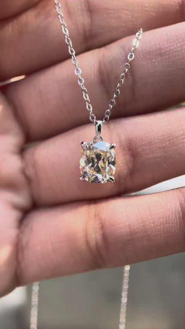 Elongated cushion Old Mine cut moissanite pendant necklace in white gold showing brilliance and movement