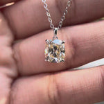 Elongated cushion Old Mine cut moissanite pendant necklace in white gold showing brilliance and movement