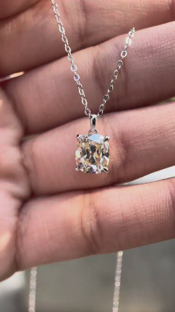 Elongated cushion Old Mine cut moissanite pendant necklace in white gold showing brilliance and movement