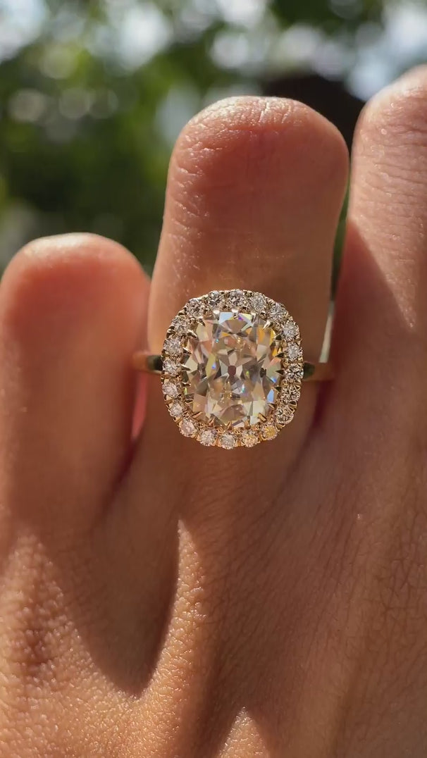 Light champagne moissanie halo wedding ring yellow gold video