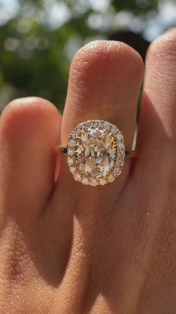 Light champagne moissanie halo wedding ring yellow gold video
