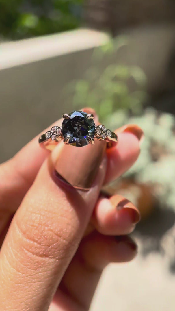 Round Old European cut bluish grey moissanite engagement ring rotating view