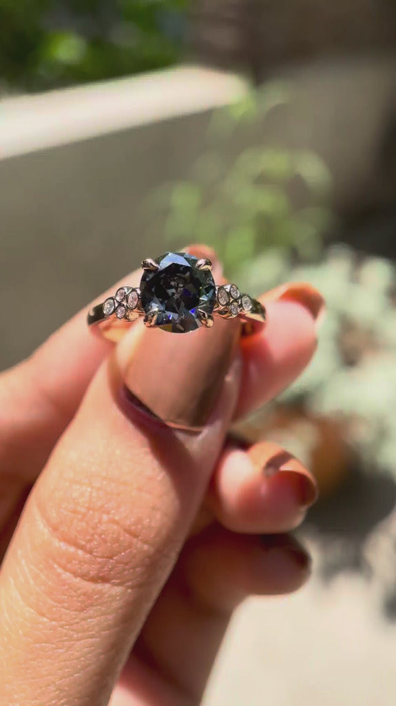 Round Old European cut bluish grey moissanite engagement ring rotating view