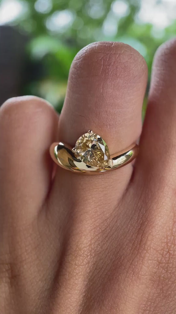 Chunky pear moissanite ring showcasing bold yellow gold design