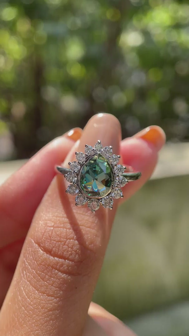Pear rose cut moissanite halo ring in natural light rotation