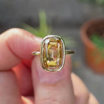 Video showcasing the elongated champagne moissanite bezel ring in  yellow gold.