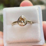 Pear Old Mine Cut light champagne moissanite bezel solitaire ring rotating view