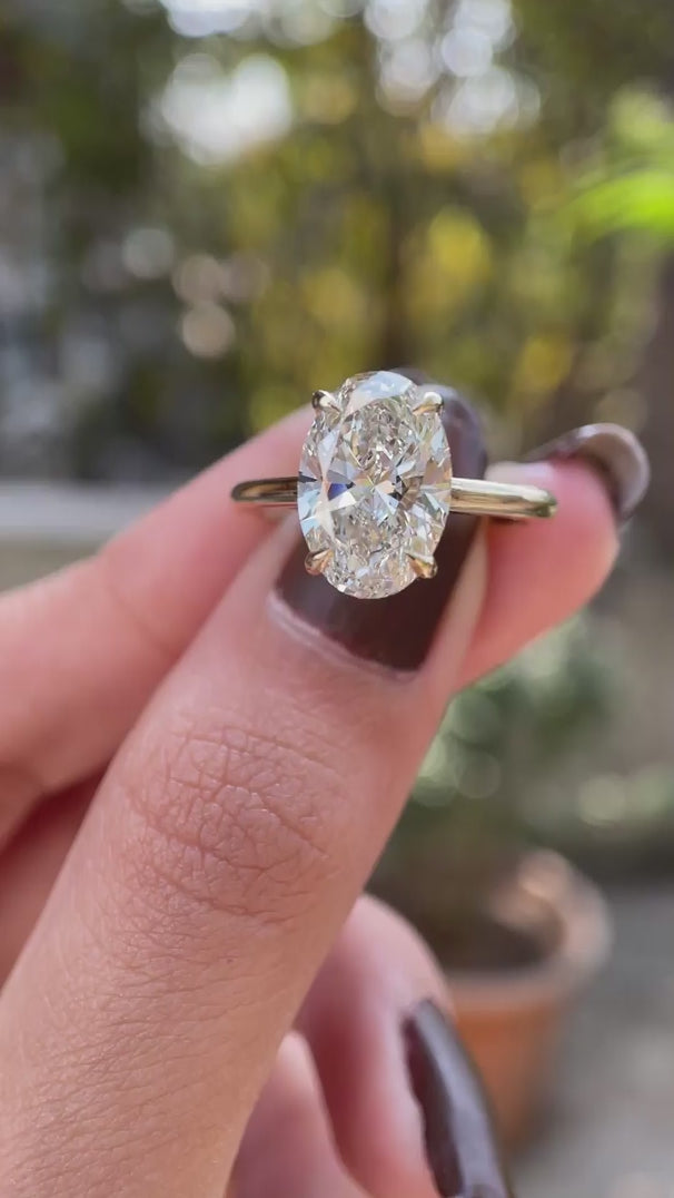 Hidden halo oval moissanite engagement cathedral ring yellow gold