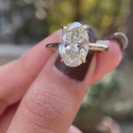 Hidden halo oval moissanite engagement cathedral ring yellow gold