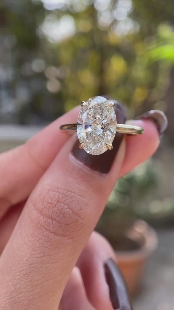 Hidden halo oval moissanite engagement cathedral ring yellow gold