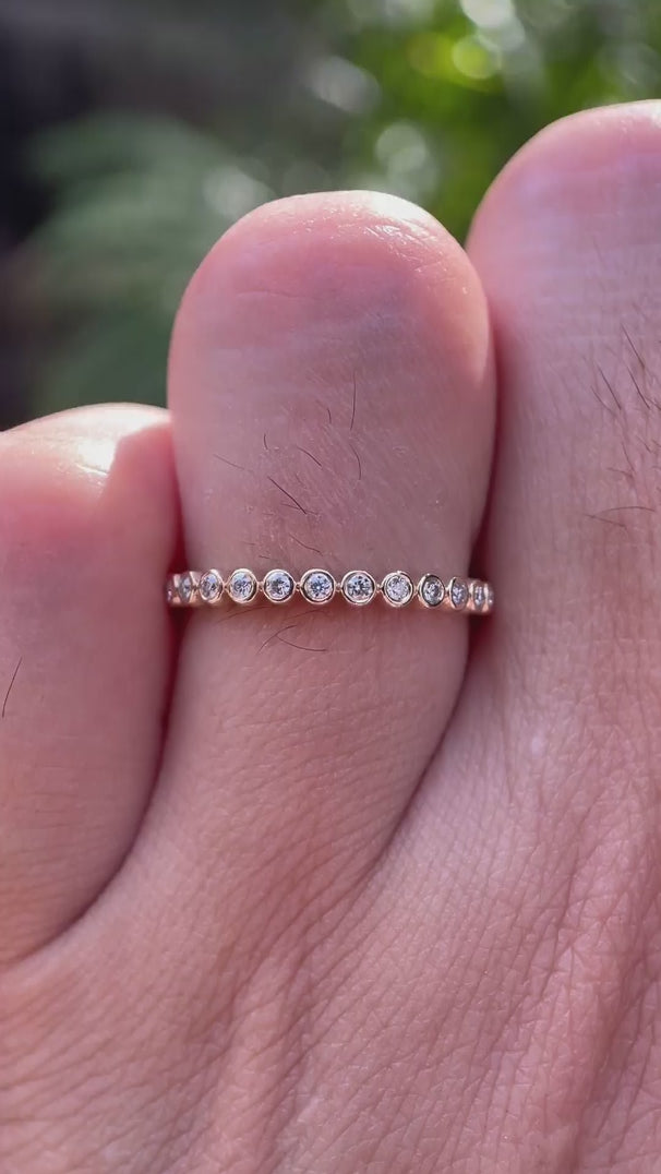 Video showcasing floating bubble half eternity band sparkle and profile on finger.