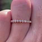 Video showcasing floating bubble half eternity band sparkle and profile on finger.