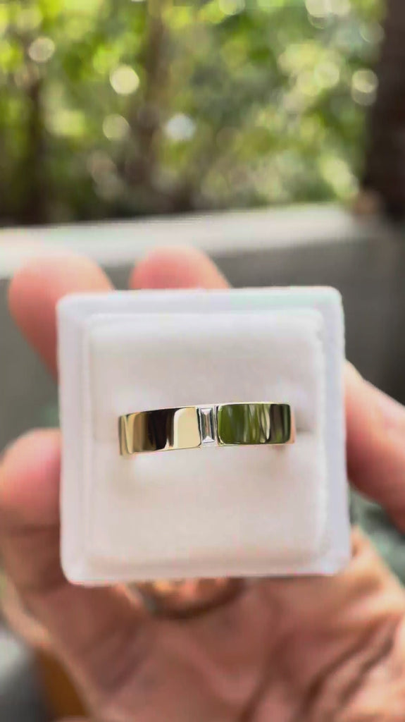 Video showcasing the cigar band rotating to highlight the comfort fit design and flush set baguette moissanite.
