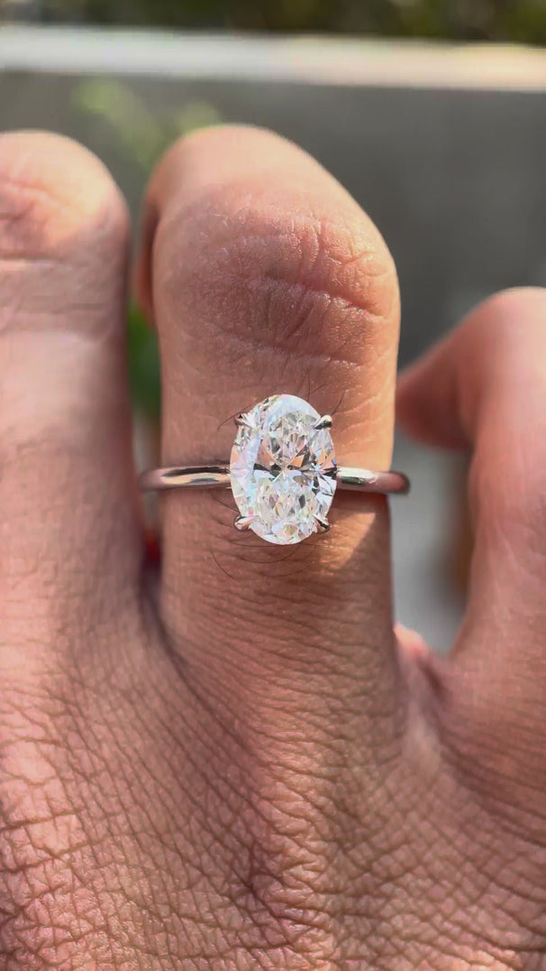Oval lab grown diamond solitaire cathedral ring with hidden halo in 14K white gold video view