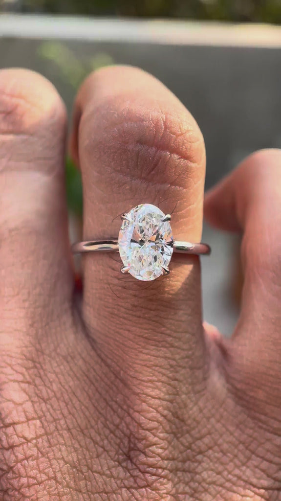 Oval lab grown diamond solitaire cathedral ring with hidden halo in 14K white gold video view