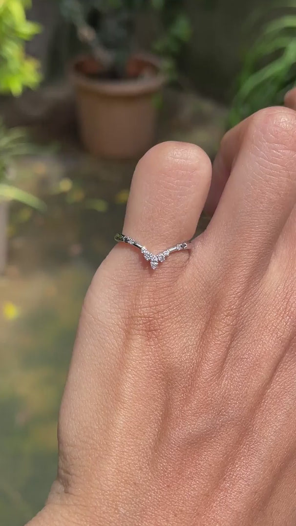 Dainty platinum stacking ring with curved chevron shape and contrasting black and white gemstone accents