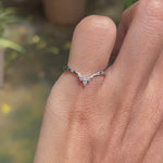Dainty platinum stacking ring with curved chevron shape and contrasting black and white gemstone accents