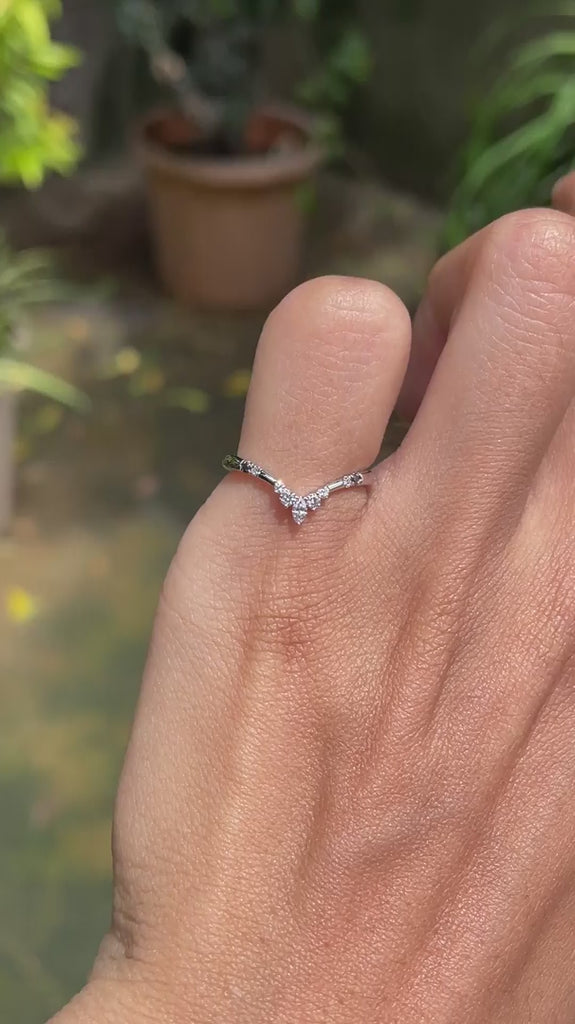 Dainty platinum stacking ring with curved chevron shape and contrasting black and white gemstone accents