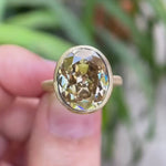 Bezel set oval champagne ring rotating in hand