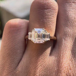 Rotating video of Asscher three stone ring showcasing step cut sparkle and double claw prongs