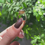 18k yellow gold East West oval dark champagne moissanite ring with tulip set and cathedral band
