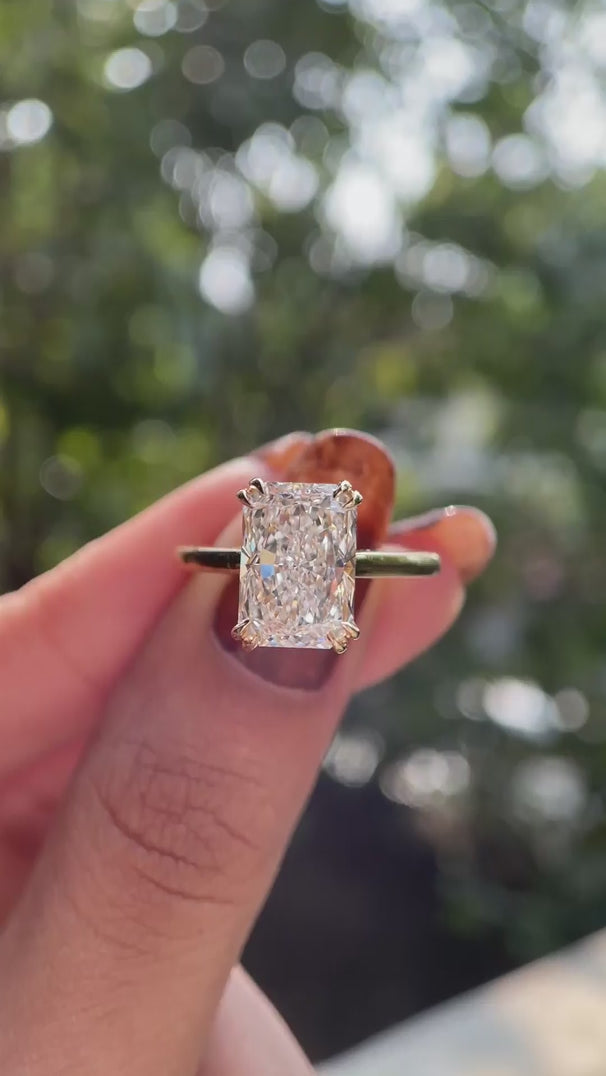 Hidden halo radiant cut engagement ring glossy yellow gold video