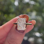 Hidden halo radiant cut engagement ring glossy yellow gold video