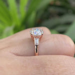 Round Old European Cut moissanite three stone ring with baguette side stones in 10K rose gold rotating view