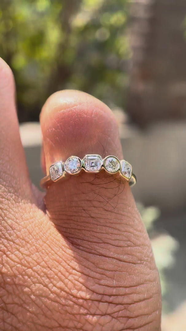 Video showing five-stone moissanite band sparkle and low-profile fit.