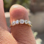 Video showing five-stone moissanite band sparkle and low-profile fit.