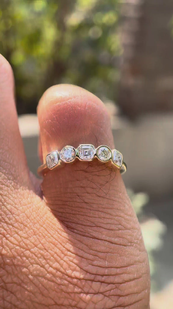Video showing five-stone moissanite band sparkle and low-profile fit.