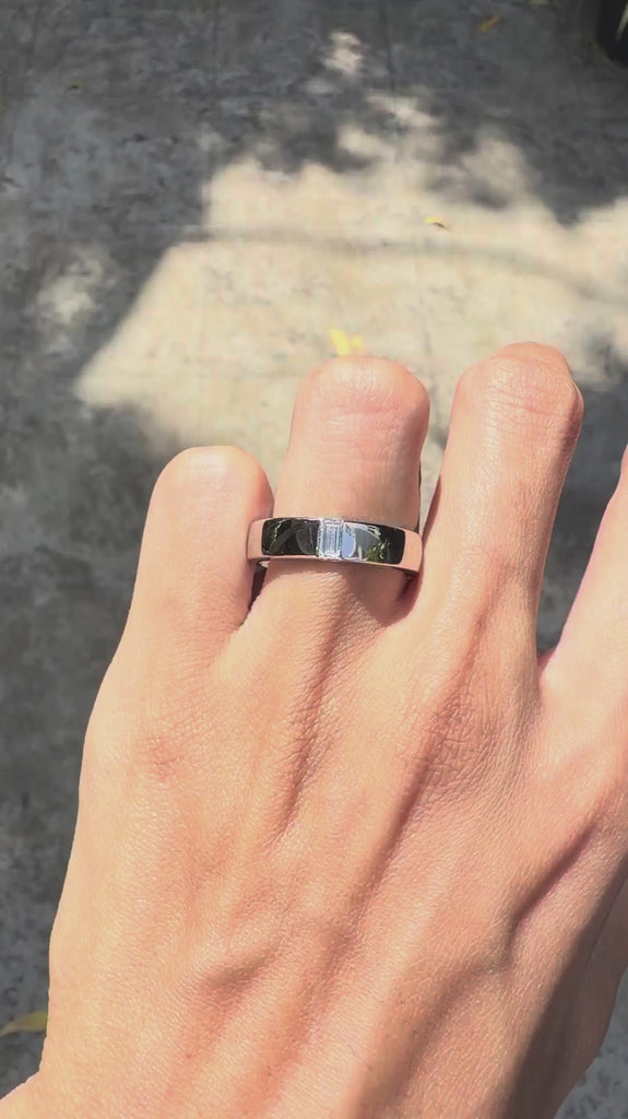 Unique platinum men’s wedding ring featuring baguette diamond and modern flat band style