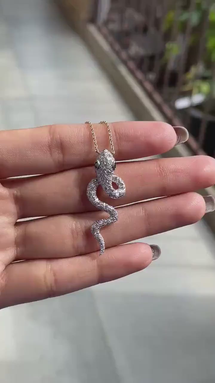 Iced out diamond serpent pendant with emerald green eyes video