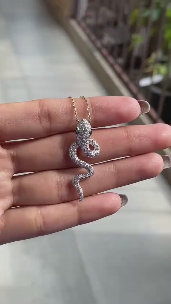 Iced out diamond serpent pendant with emerald green eyes video