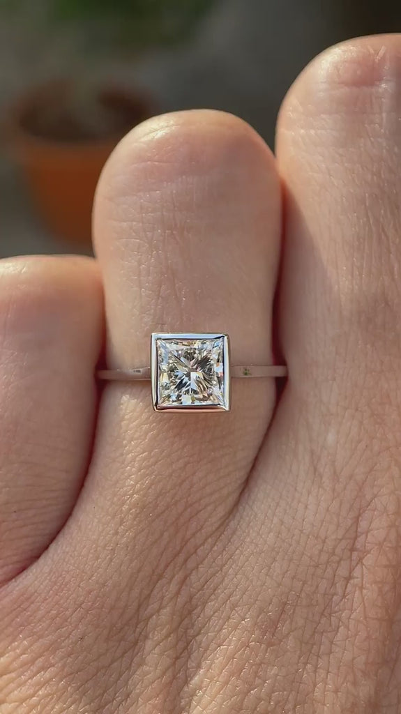 Princess cut lab grown diamond bezel solitaire ring in 14K white gold rotating view