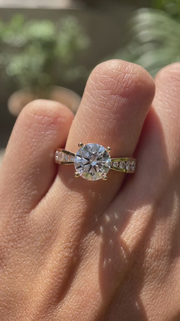 Channel set accent diamond ring with 8 mm round center stone video