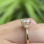 Video showing the 10K yellow gold engagement ring with a square cushion moissanite center stone and round brilliant-cut side stones, highlighting its high-polish finish and elegant design.