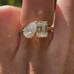Close-up video of pear and emerald cut toi et moi ring in yellow gold