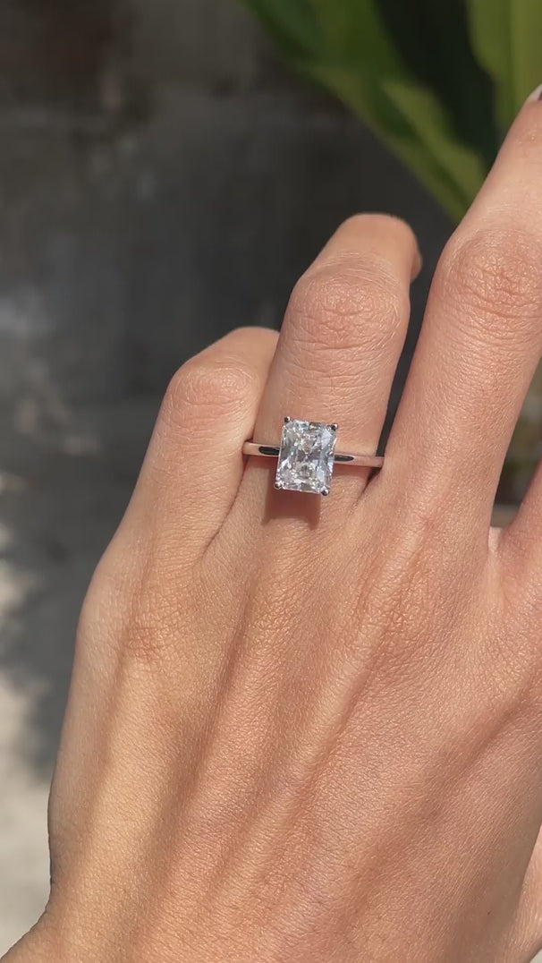 Radiant cut moissanite solitaire ring on hand in white gold video
